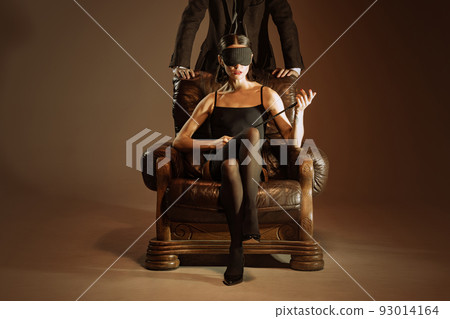 Intrigue. Vintage style portrait of man and woman in 1920s style fashion outfits isolated over dark brown background. Relationship, business, love, art, fashion Intrigue. Vintage style portrait of man and woman in 1920s style fashion outfits isolated over dark brown background. Relationship, business, love, art, fashion 93014164
