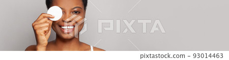 Beauty portrait of a happy cheerful young female face with a cotton pad 93014463