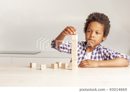 Serious kid with empty wooden cubes portrait 93014669