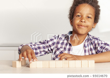 Happy preschool age child play with wooden toy blocks 93014670