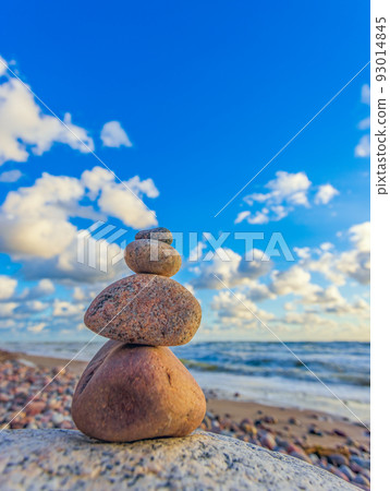 Stone tower on the beach with evening sunset light Stone tower on the beach with evening sunset light 93014845