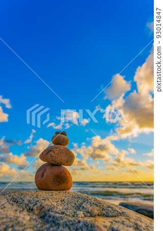 Stone tower on the beach with evening sunset light Stone tower on the beach with evening sunset light 93014847