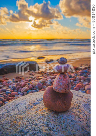 Stone tower on the beach with evening sunset light Stone tower on the beach with evening sunset light 93014850