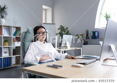 Asian business woman is sick in the office, has severe stomach pain, nausea and diarrhea. Asian business woman is sick in the office, has severe stomach pain, nausea and diarrhea. 93015359