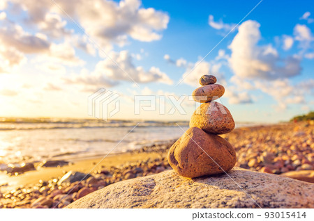 Stone tower on the beach with evening sunset light Stone tower on the beach with evening sunset light 93015414