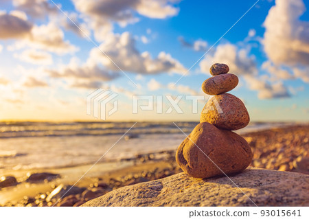 Stone tower on the beach with evening sunset light 93015641