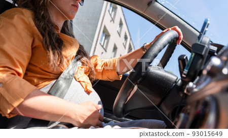 Pregnancy woman driving car. Young smiling pregnant woman driving car. Safety pregnancy young mother drive concept. Pregnancy woman driving car. Young smiling pregnant woman driving car. Safety pregnancy young mother drive concept. 93015649