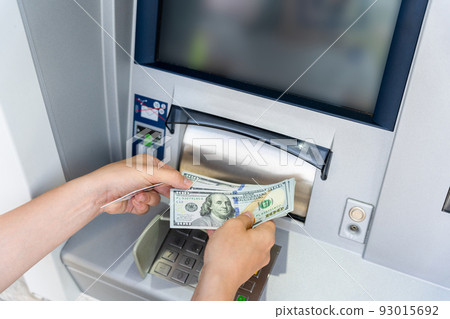 Atm card machine cash. Holding american bill cash. Woman withdraw money usd hundred dollar. Bank credit card money background. 93015692