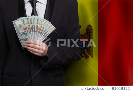 Moldavian man with 100 US dollar bills money banknotes against flag of Moldova background 93019333