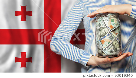 Business and currency exchange in Georgia concept. Hands, US dollars and Georgian flag 93019340