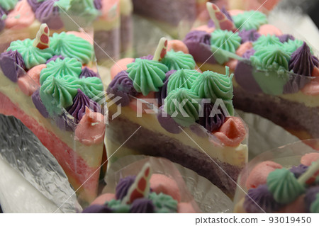 Slices of colorful summer themed frosted cakes Slices of colorful summer themed frosted cakes 93019450