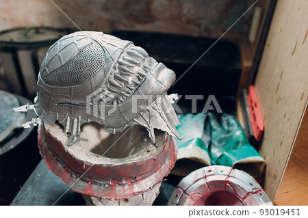 Artisan craftsman create mask based on plaster cast. Gypsum mold and plastic mask sculpting. Artisan craftsman create mask based on plaster cast. Gypsum mold and plastic mask sculpting. 93019451