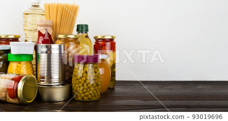 Emergency survival food set on dark wooden kitchen table 93019696