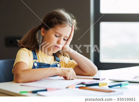 Confused child doing homework at home 93019981