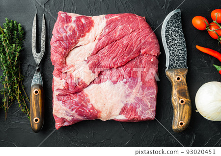 Raw piece of marble beef brisket,with ingredients for smoking  making  barbecue, pastrami, cure, on black stone background, top view flat lay 93020451