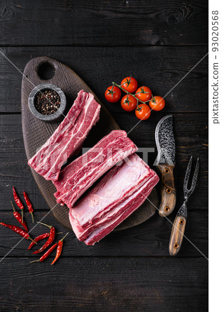 Fresh  premium wagyu beef rib, on black wooden table background, top view flat lay 93020568