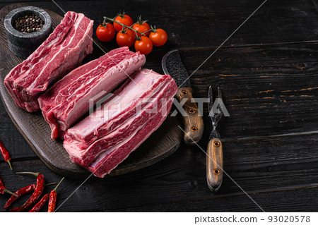 Fresh premium wagyu beef rib, on black wooden table background, with copy space for text Fresh premium wagyu beef rib, on black wooden table background, with copy space for text 93020578