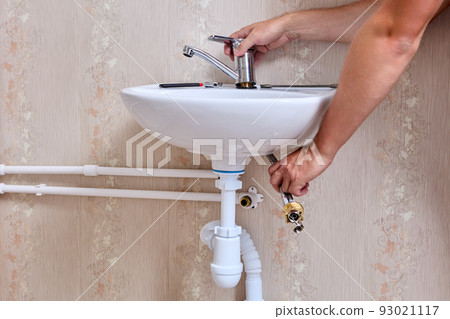 Plumber installs new water faucet in home piping system. 93021117
