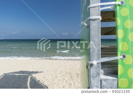 Beach umbrella against the blue clear sky on the beach 93021330
