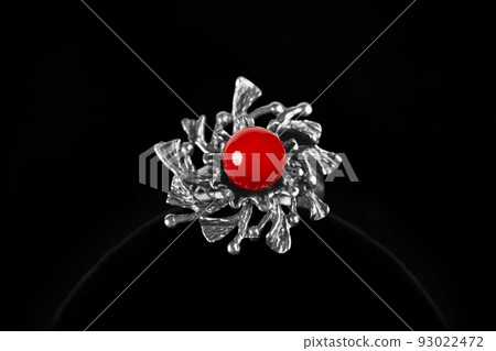 Silver ring with coral stone on black background Silver ring with coral stone on black background 93022472
