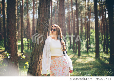 Young beautiful hippie woman walks in the summer forest laughs dances and enjoys life and nature Young beautiful hippie woman walks in the summer forest laughs dances and enjoys life and nature 93022675