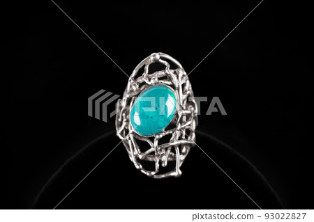 Silver ring with turquoise stone on black background Silver ring with turquoise stone on black background 93022827