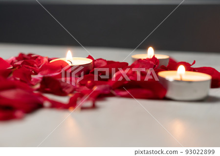 Scattered rose petals and candles, aromatic rose fragrance and candle aroma. Scattered rose petals and candles, aromatic rose fragrance and candle aroma. 93022899