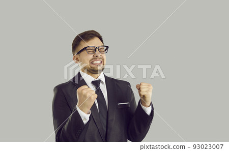 Young overjoyed Caucasian man manager makes winning gesture due to success in career or business 93023007