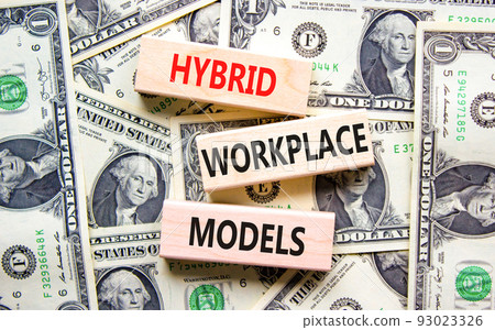 Hybrid workplace models symbol. Concept words Hybrid workplace models on wooden blocks on dollar bills. Beautiful background from dollar bills. Business hybrid workplace models concept. Copy space 93023326