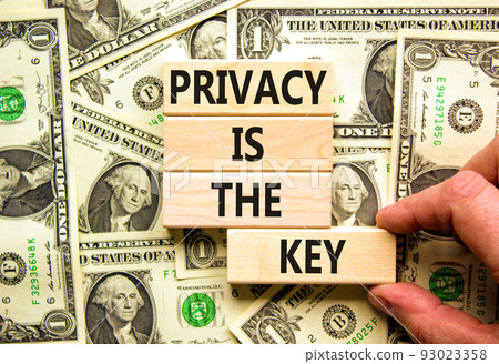 Privacy is the key symbol. Concept words Privacy is the key on wooden blocks on a beautiful background from dollar bills. Businessman hand. Business, finacial and privacy is the key concept. Privacy is the key symbol. Concept words Privacy is the key on wooden blocks on a beautiful background from dollar bills. Businessman hand. Business, finacial and privacy is the key concept. 93023358