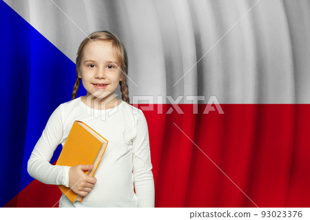 Small girl child smiling and holding book Small girl child smiling and holding book 93023376
