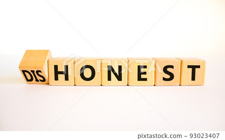 Honest or dishonest symbol. Turned cube and changed the concept word Dishonest to Honest. Beautiful white table white background. Business and honest or dishonest concept. Copy space. Honest or dishonest symbol. Turned cube and changed the concept word Dishonest to Honest. Beautiful white table white background. Business and honest or dishonest concept. Copy space. 93023407