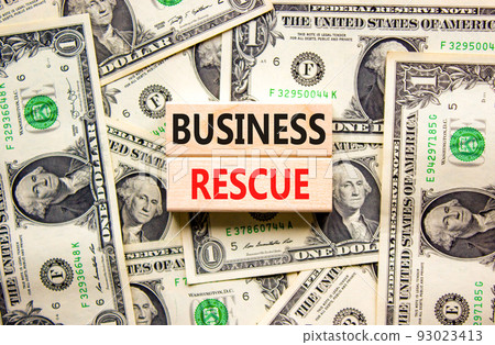 Business rescue symbol. Concept words Business rescue on wooden blocks on a beautiful background from dollar bills. Business rescue and support concept. Copy space. Business rescue symbol. Concept words Business rescue on wooden blocks on a beautiful background from dollar bills. Business rescue and support concept. Copy space. 93023413