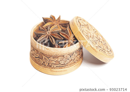 Anise in a wooden box isolated on white background. Dried star anise spice fruits Anise in a wooden box isolated on white background. Dried star anise spice fruits 93023714