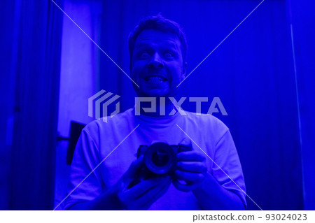 man making selfie in strange blue light. man making selfie in strange blue light. 93024023