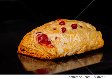 One baked bun with red strawberry jam in electric oven: close up 93024688