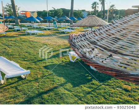 Bamboo beach umbrella on blue sky background Bamboo beach umbrella on blue sky background 93025048