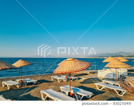 Bamboo beach umbrella on blue sky background Bamboo beach umbrella on blue sky background 93025049