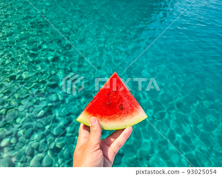 Bright red watermelon on blue sea background. Bright red watermelon on blue sea background. 93025054
