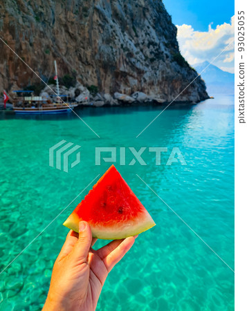 Bright red watermelon on blue sea background. Bright red watermelon on blue sea background. 93025055