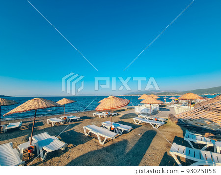Bamboo beach umbrella on blue sky background Bamboo beach umbrella on blue sky background 93025058