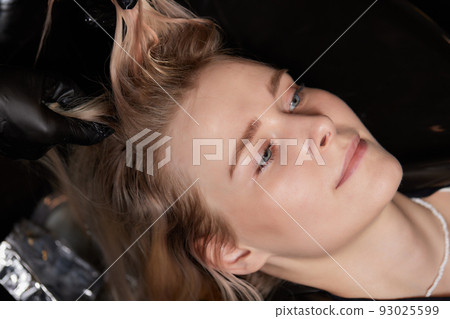 Airtouch Hair stylist makes bouffant using comb on thin strands. Shatush technique for hair lightening. 93025599