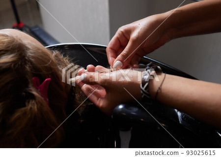 Airtouch Hair stylist makes bouffant using comb on thin strands. Shatush technique for hair lightening. 93025615