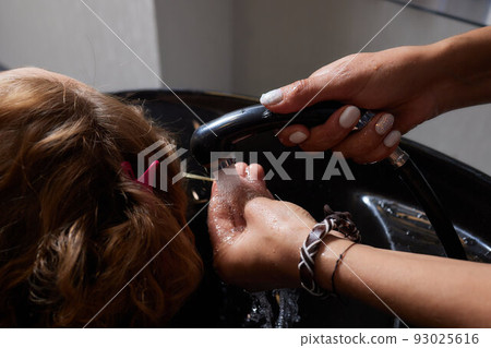 Airtouch Hair stylist makes bouffant using comb on thin strands. Shatush technique for hair lightening. 93025616