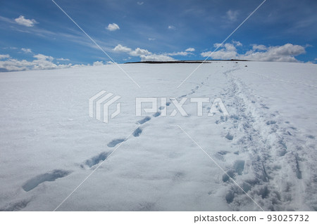 Snowcapped mountain with alpinist footprints in Jotunheimen, Norway Snowcapped mountain with alpinist footprints in Jotunheimen, Norway 93025732