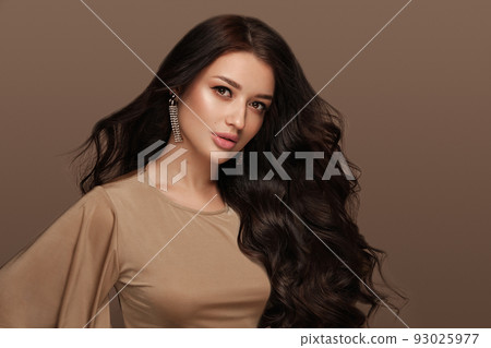 Beautiful brown-haired girl with a perfectly curls hair, and classic make-up. Beauty face and hair. 93025977