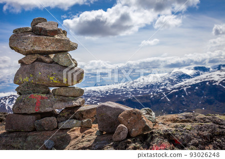 Inukshuk, Stacked stones above jotunheimen mountains in Norway Inukshuk, Stacked stones above jotunheimen mountains in Norway 93026248