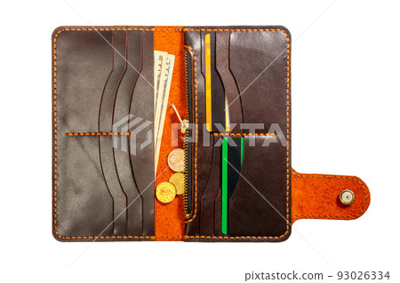 Open red leather clutch with money and credit cards 93026334
