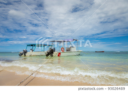 Dramatic sky over beach with motorboat, Negril Seven Mile Beach, Jamaica Dramatic sky over beach with motorboat, Negril Seven Mile Beach, Jamaica 93026489