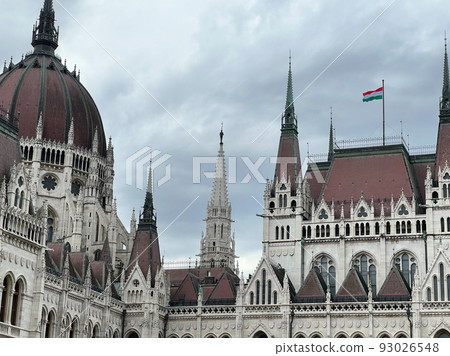 Spires of the Hungarian Parliament with a waving flag. Budapest 93026548
